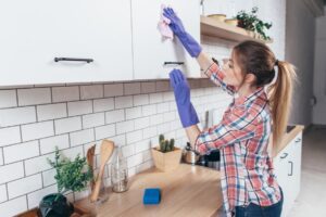 Woman cleaning cabinets