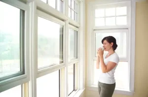 Person looking out a set of windows